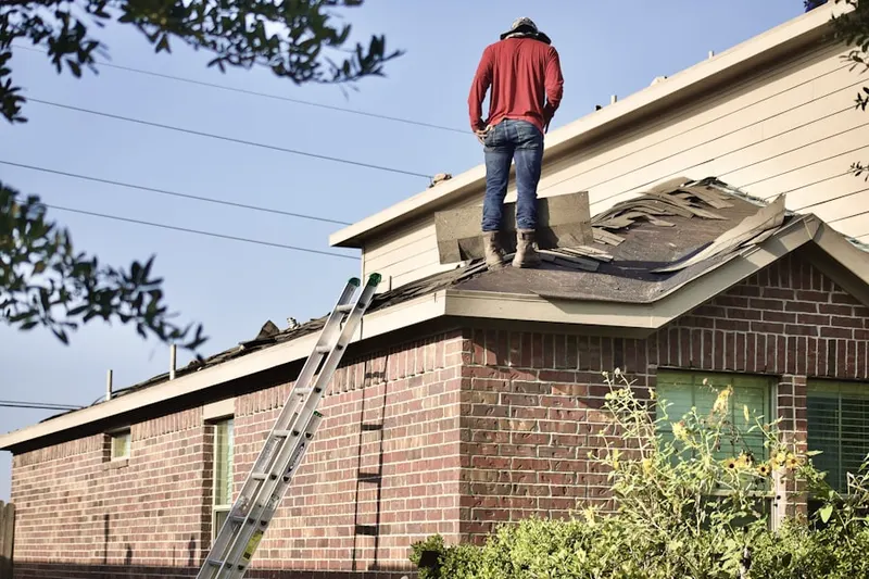 Professional roofer working on a residential roof in Workman